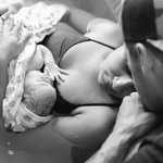 Thumbnail: A mother and father gaze at their newborn.