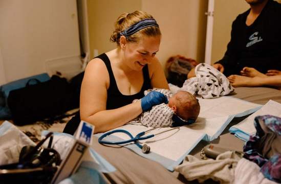 Karen smiles as she assesses a new baby's health.
