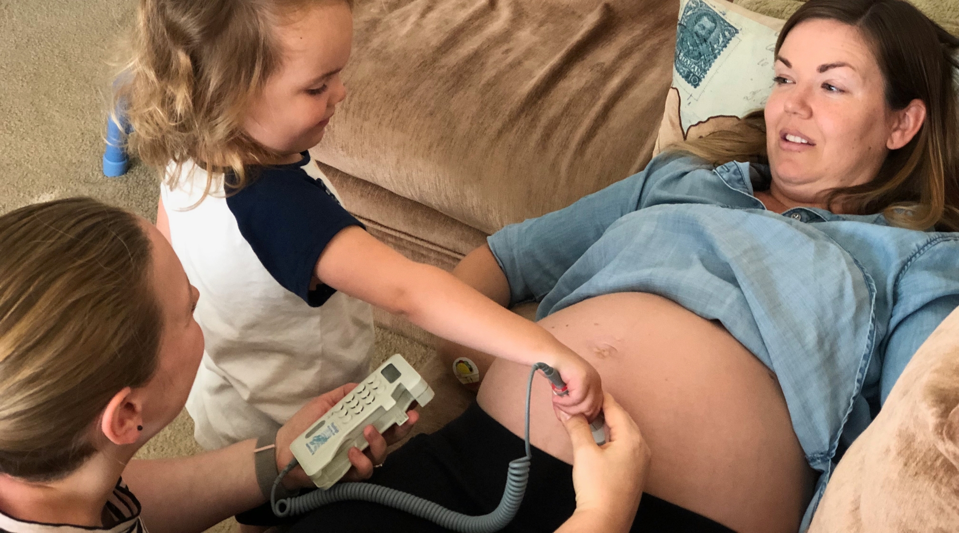 An older sibling helps Karen use the Doppler to check baby's heartbeat.