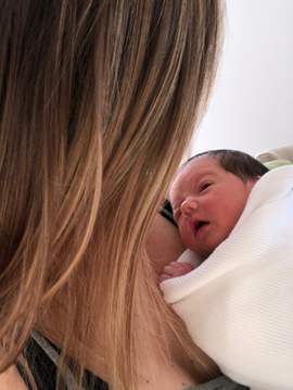 A new baby looks up at her mother.