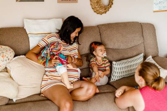 Karen talks to mother and daughter, who has a huge smile on her face.