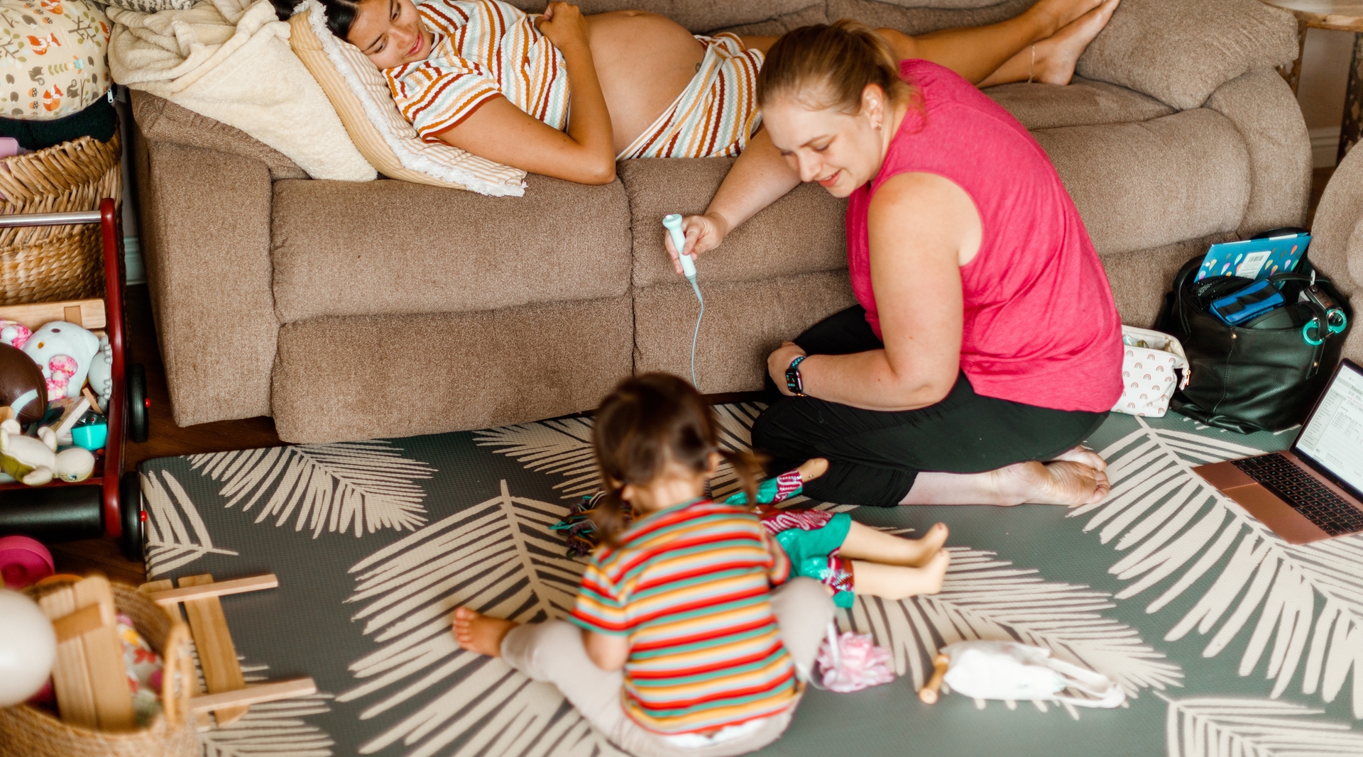 Karen uses a Doppler machine to check baby's heartbeat, while older sister pretends to do the same for her doll.